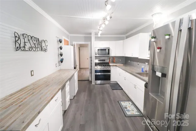 a large kitchen with a large window and stainless steel appliances