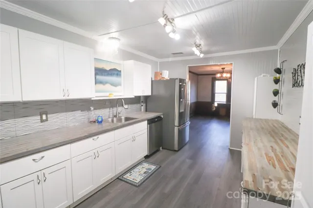 a spacious bathroom with a sink a mirror and shower