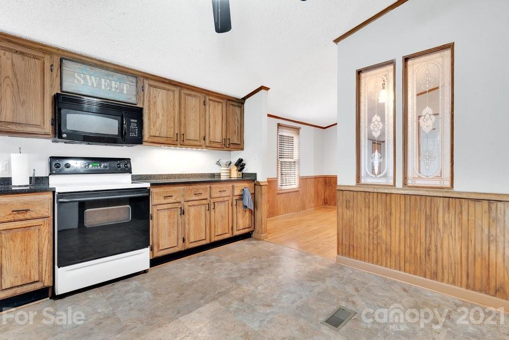 3683 Big Island Road Rutherfordton, NC 28139 - Photo 21 of 41 a kitchen with stainless steel appliances granite countertop a stove and a microwave