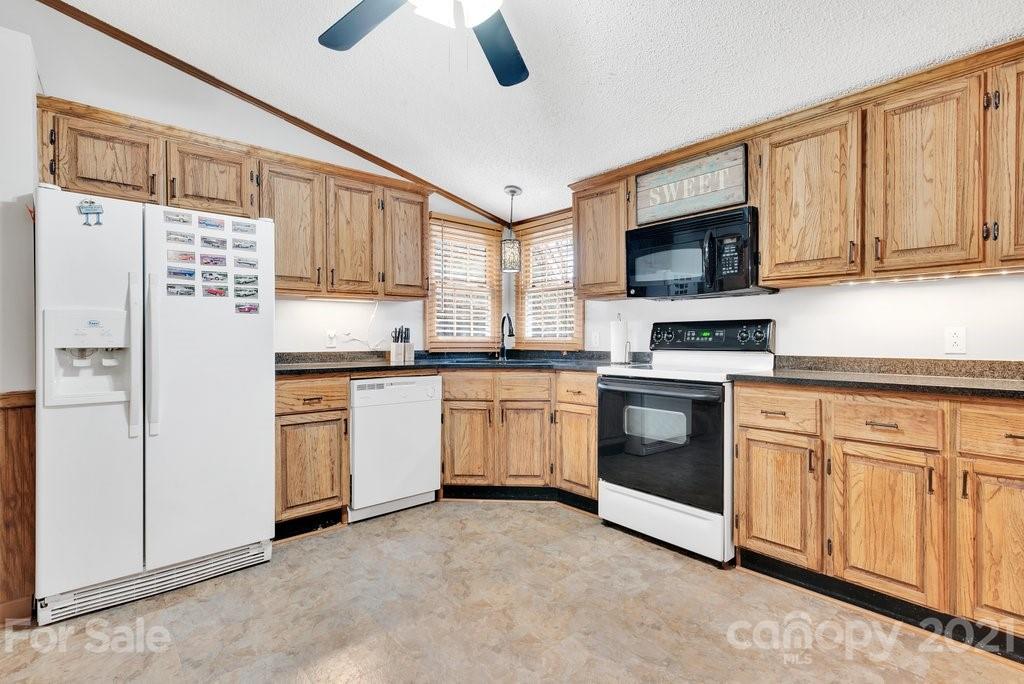 3683 Big Island Road Rutherfordton, NC 28139 - Photo 22 of 41 a kitchen with white cabinets stainless steel appliances and a window