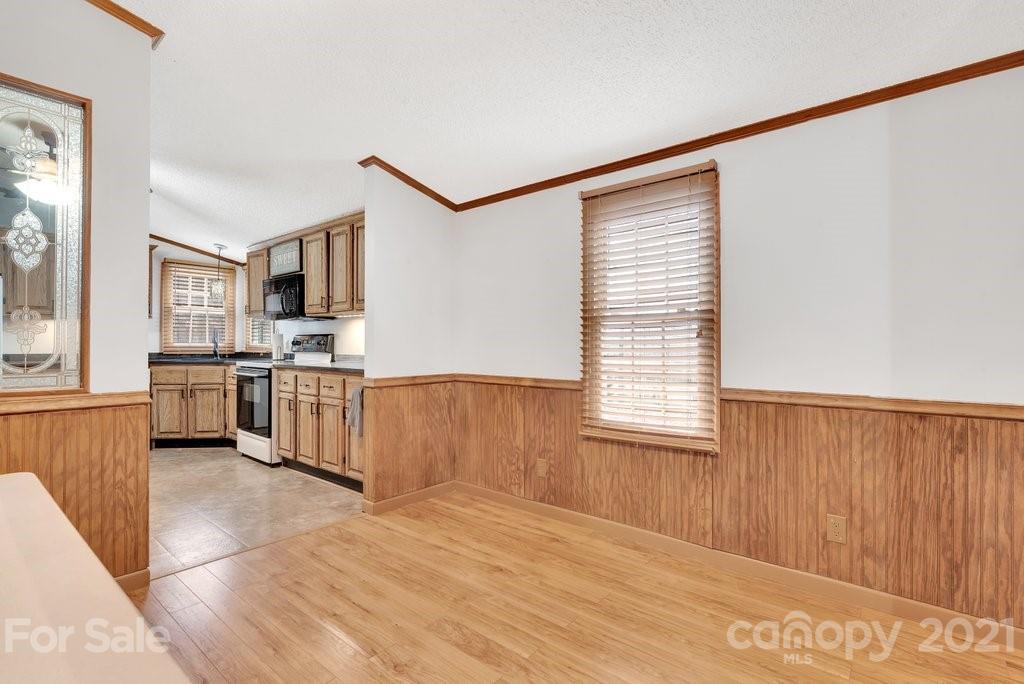 3683 Big Island Road Rutherfordton, NC 28139 - Photo 25 of 41 a kitchen with stainless steel appliances kitchen island granite countertop a stove a sink and a microwave