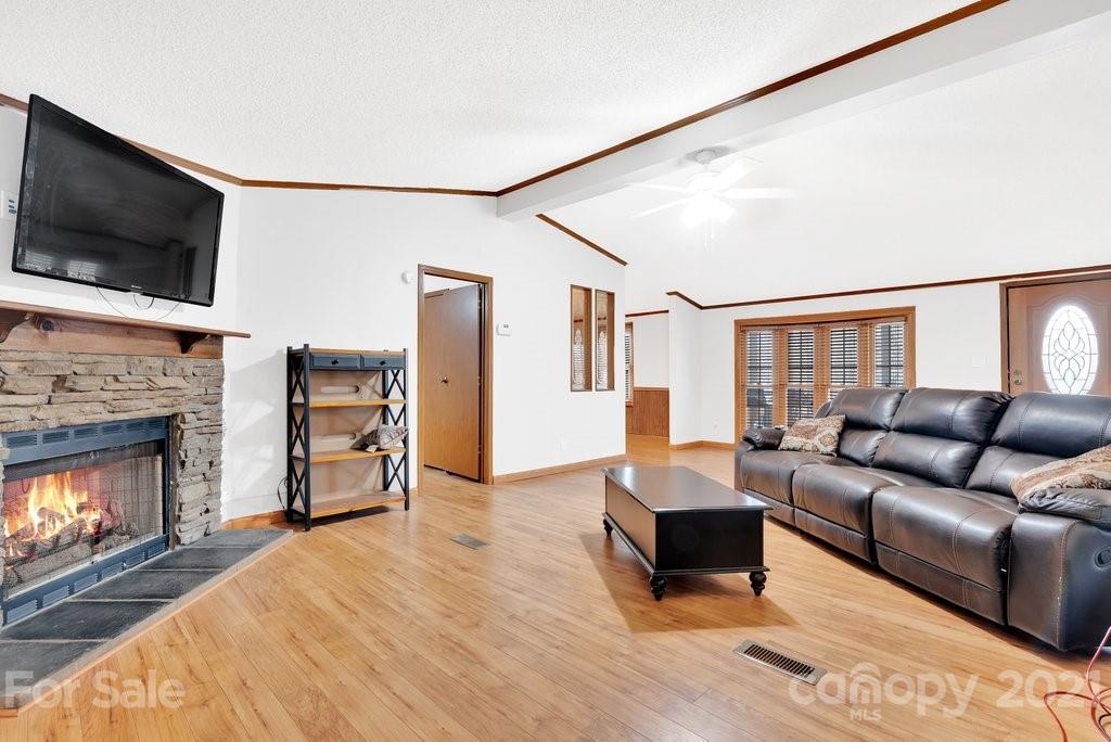3683 Big Island Road Rutherfordton, NC 28139 - Photo 29 of 41 a living room with furniture a flat screen tv and a fireplace