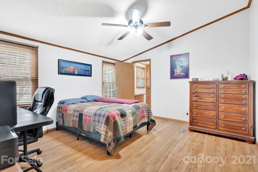 3683 Big Island Road Rutherfordton, NC 28139 - Photo 30 of 41 a bedroom with a bed a dresser and chair
