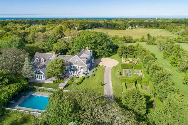 an aerial view of a house with a yard