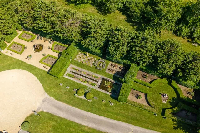 a view of a garden with lawn chairs