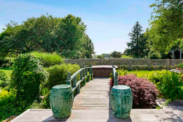 a view of a house with backyard sitting area and garden