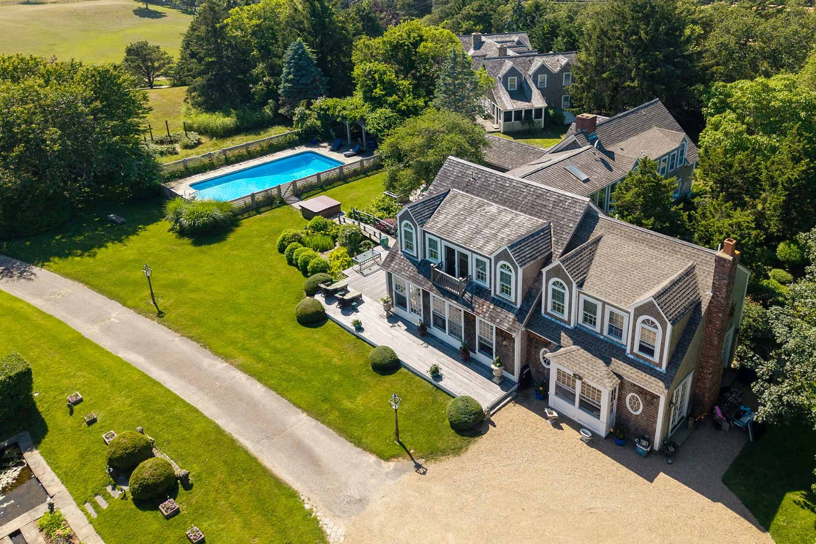 5 Louis Field Road Edgartown, MA 02539 - Photo 2 of 33 an aerial view of a house with swimming pool and large trees