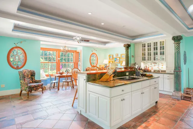a large white kitchen with a large window