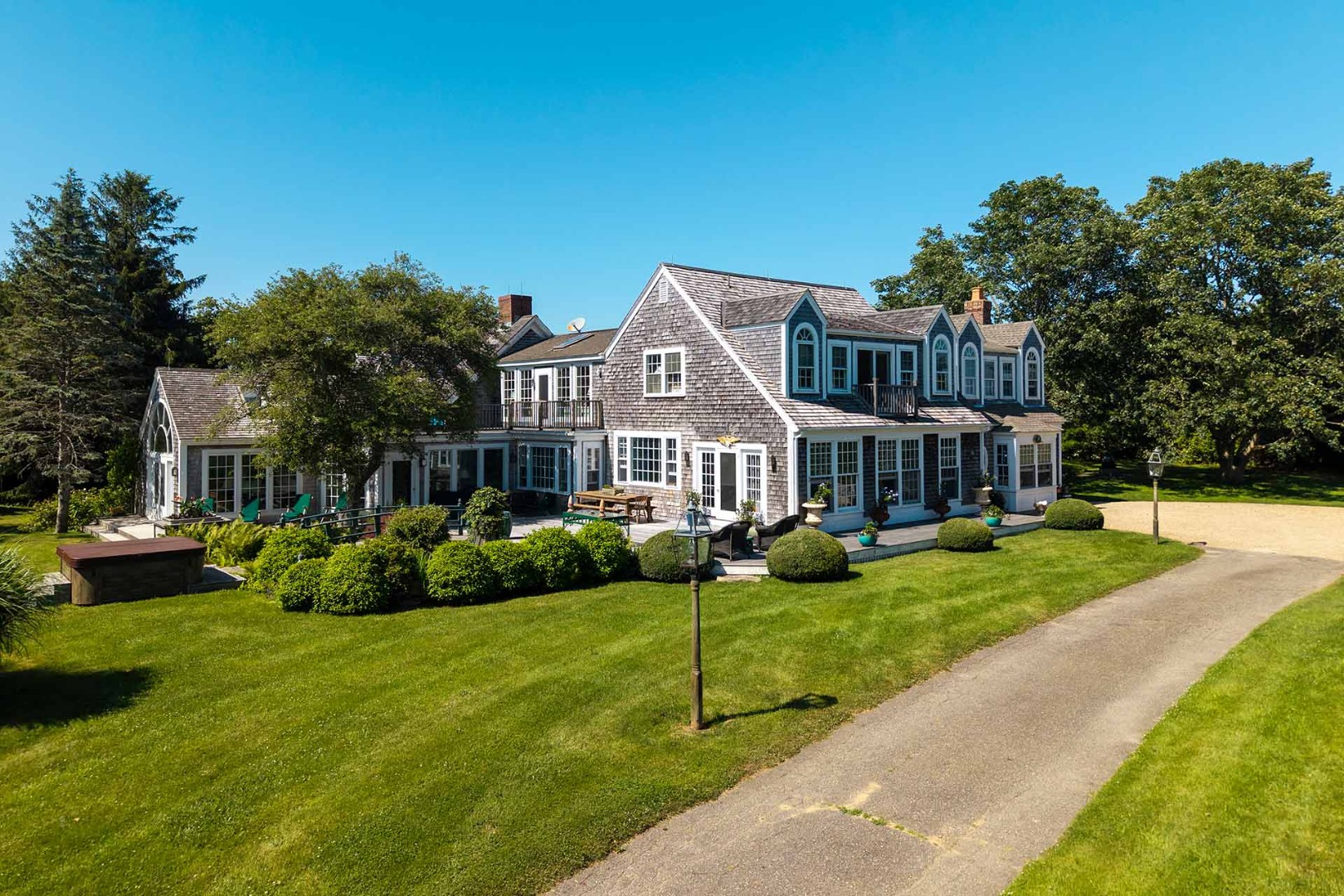 5 Louis Field Road Edgartown, MA 02539 - Photo 5 of 33 a front view of a house with a yard table and chairs