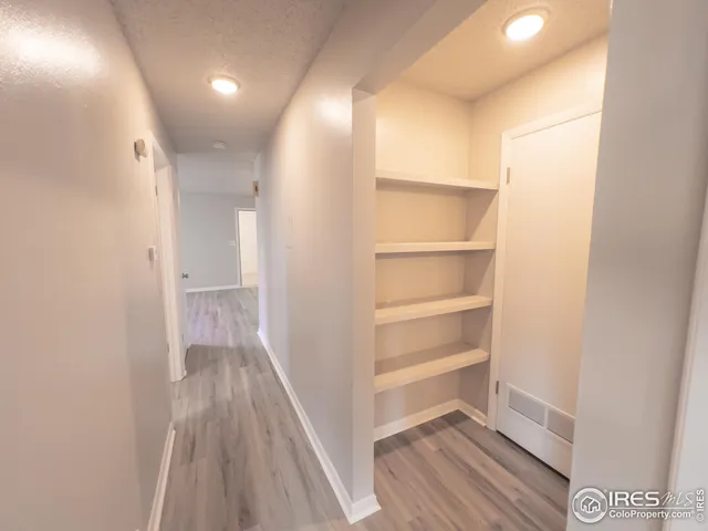 a view of a hallway with wooden floor
