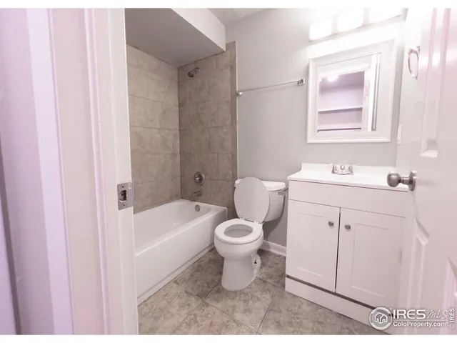 a bathroom with a sink toilet vanity and tub