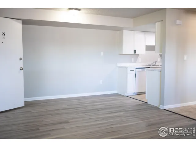 a view of a kitchen with wooden floor