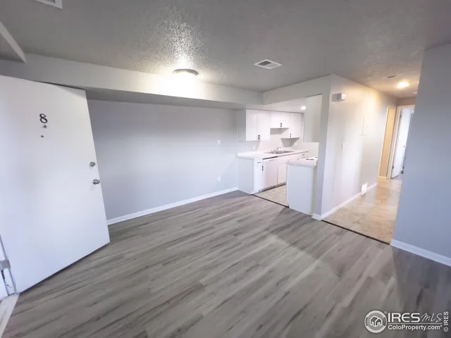 a view of a kitchen with a sink and a refrigerator
