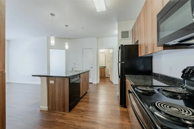 a kitchen with stainless steel appliances granite countertop a stove and a refrigerator