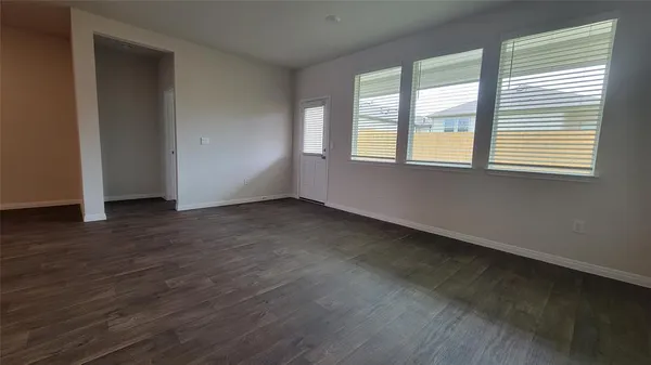 a view of kitchen with wooden floor and electronic appliances