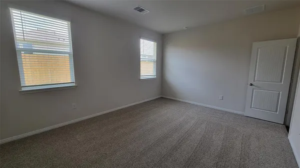 an empty room with wooden floor and closet
