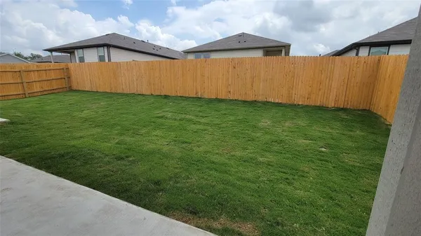 a backyard of a house with lots of green space