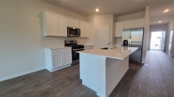a kitchen with sink and microwave