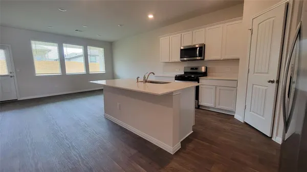 a kitchen with a refrigerator and a sink