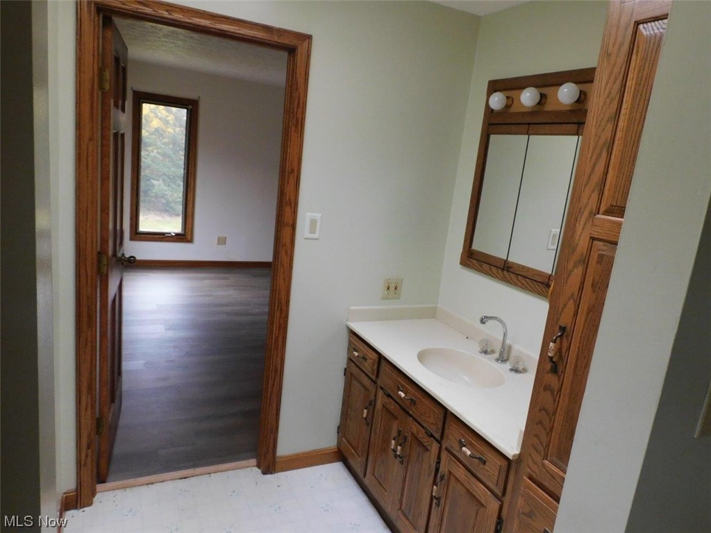 1102 Fiesta Road Southwest Dellroy, OH 44620 - Photo 16 of 20 Bathroom featuring large vanity and tile floors