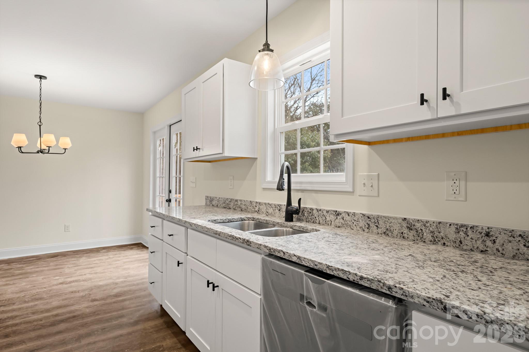 545 Washington Street Rock Hill, SC 29730 - Photo 11 of 29 a kitchen with granite countertop white cabinets and a sink