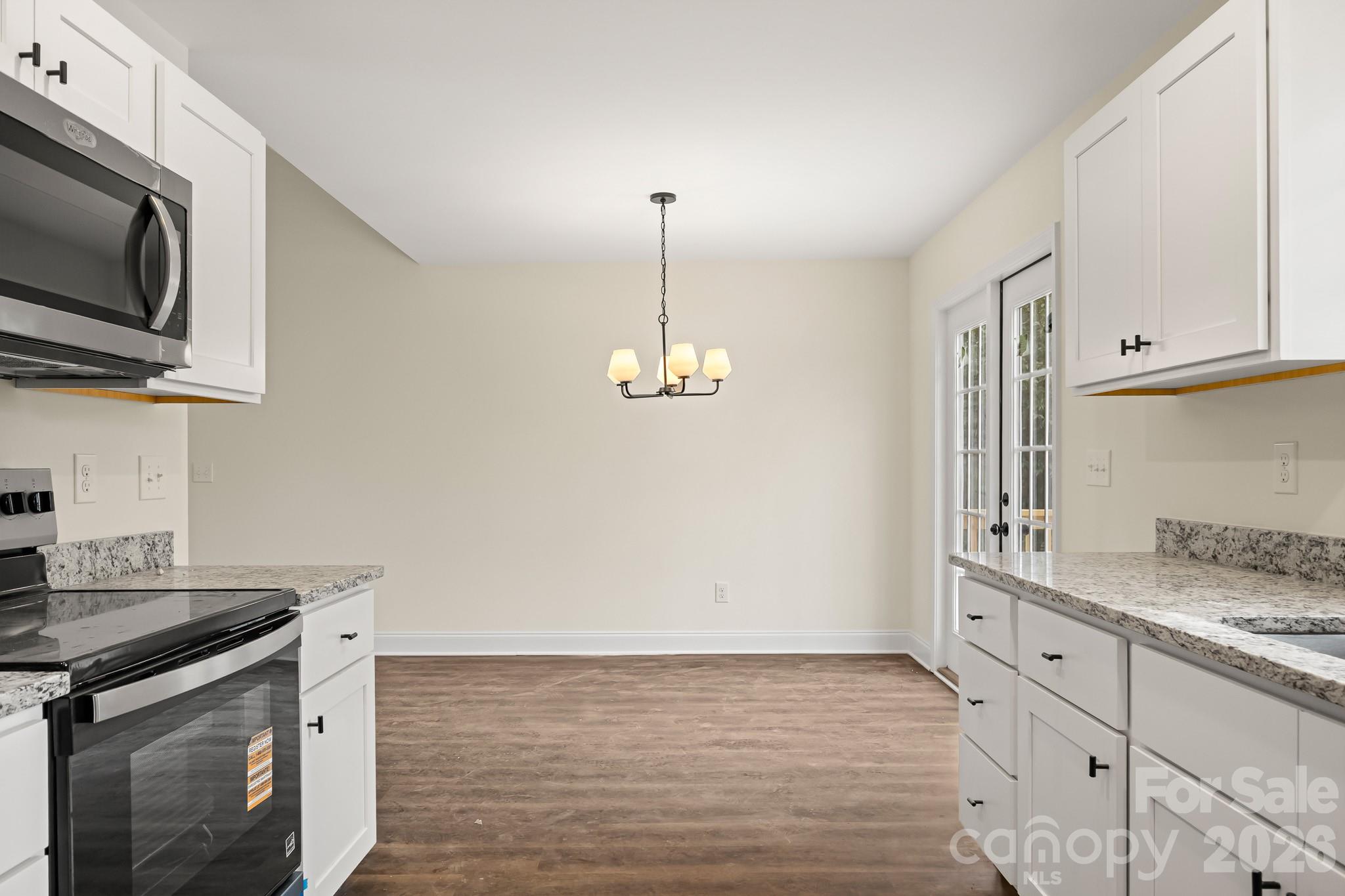545 Washington Street Rock Hill, SC 29730 - Photo 12 of 29 a kitchen with stainless steel appliances granite countertop a stove a sink and a microwave
