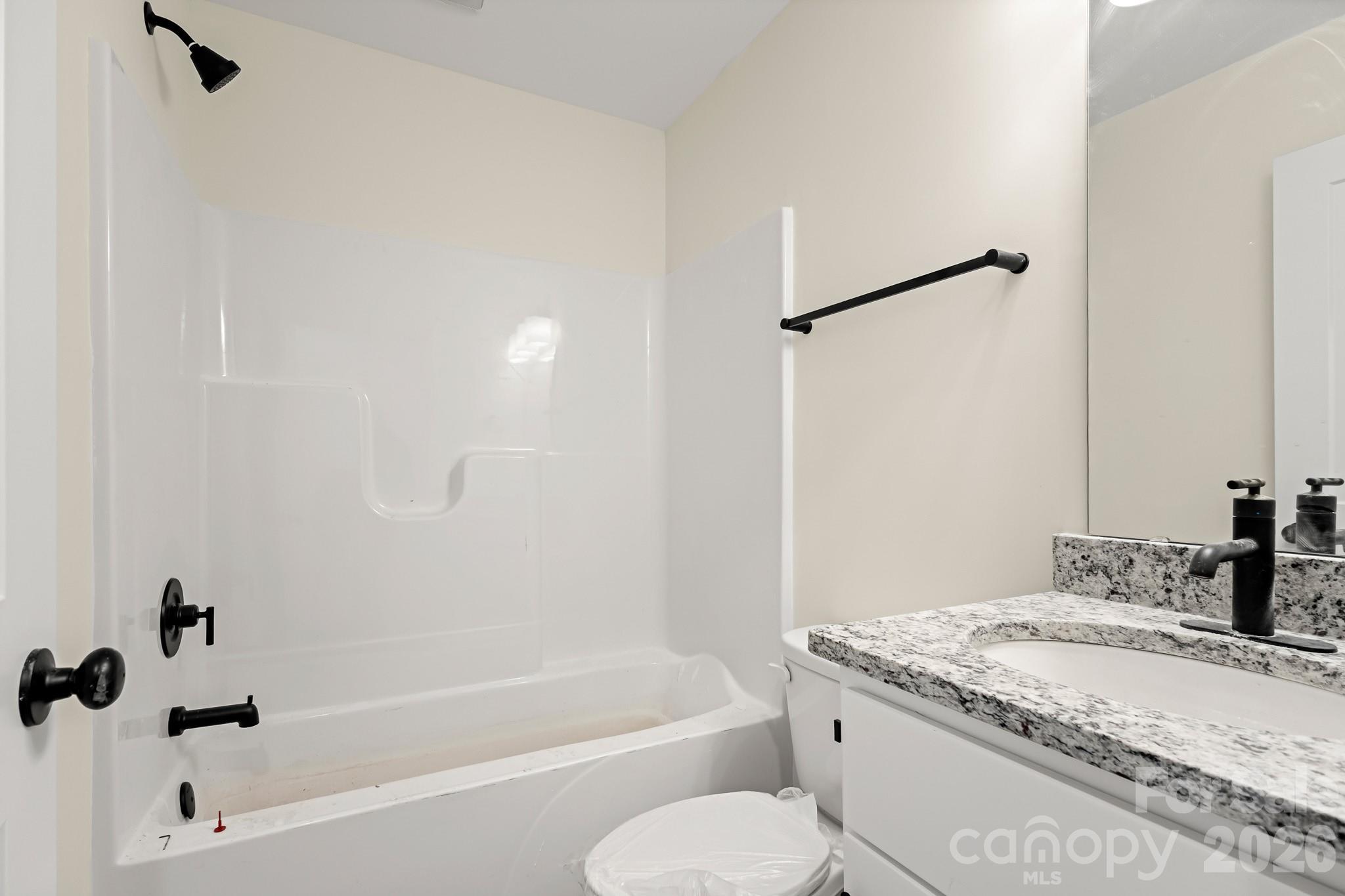 545 Washington Street Rock Hill, SC 29730 - Photo 20 of 29 a bathroom with a granite countertop sink toilet and bathtub