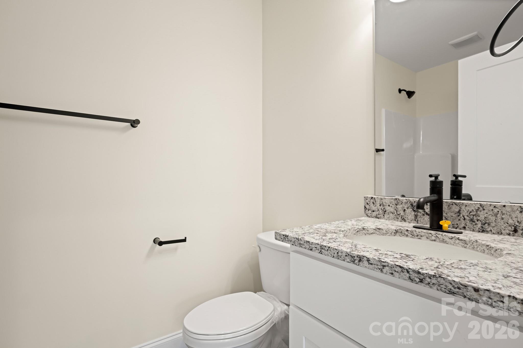 545 Washington Street Rock Hill, SC 29730 - Photo 23 of 29 a bathroom with a granite countertop sink toilet and shower
