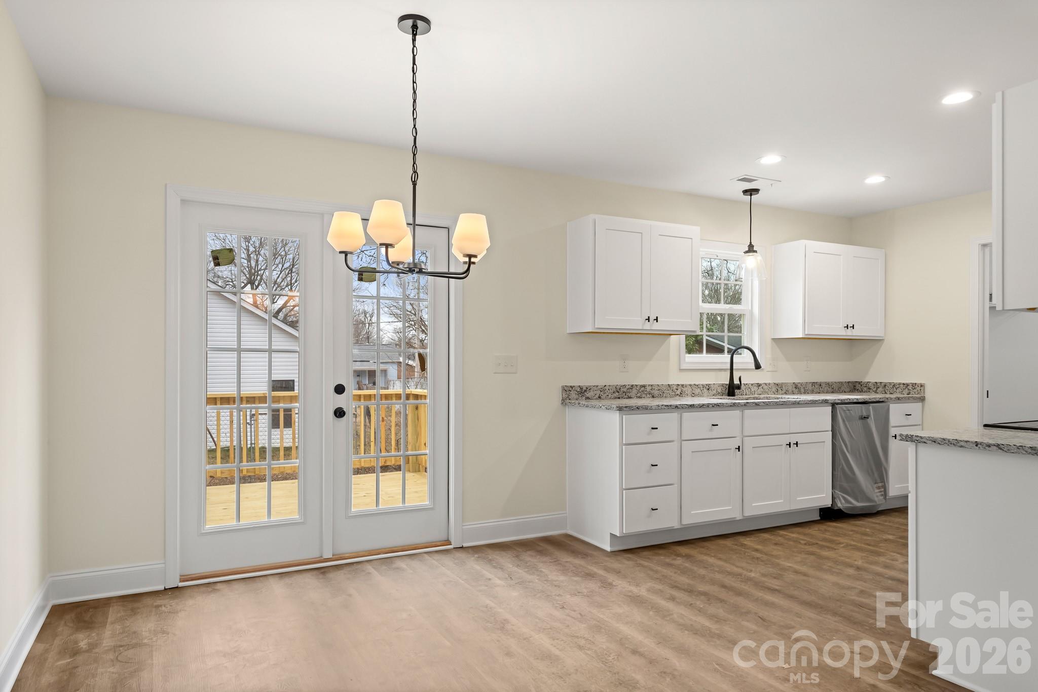 545 Washington Street Rock Hill, SC 29730 - Photo 6 of 29 a kitchen with granite countertop white cabinets and white appliances