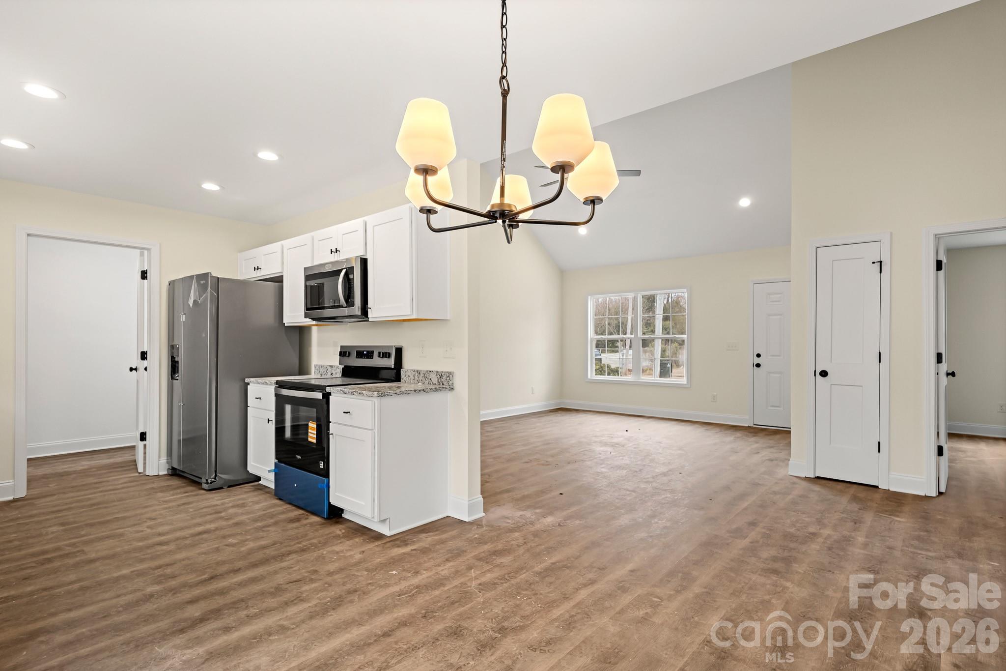 545 Washington Street Rock Hill, SC 29730 - Photo 8 of 29 a view of a kitchen with stainless steel appliances granite countertop a stove top oven a refrigerator with the cabinets
