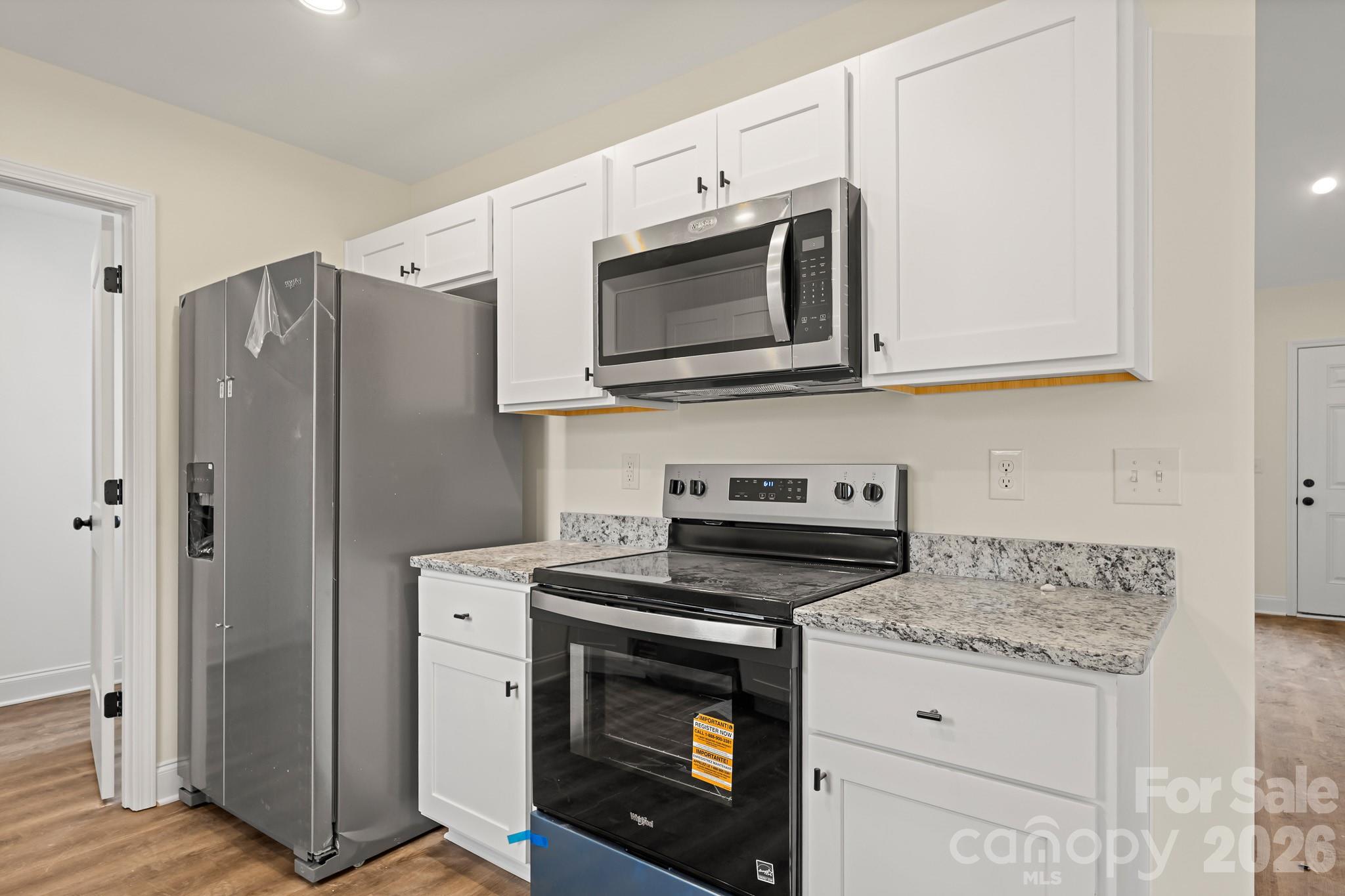 545 Washington Street Rock Hill, SC 29730 - Photo 10 of 29 a kitchen with granite countertop cabinets stainless steel appliances and wooden floor