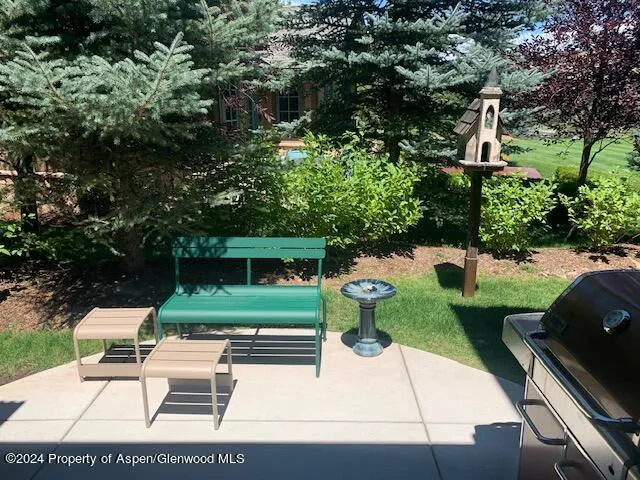a view of a backyard with sitting area