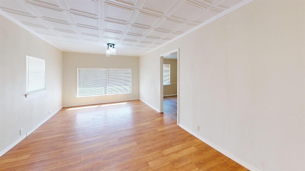 12225 Schroeder Road Dallas, TX 75243 - Photo 12 of 40 Wood-finish flooring, textured ceiling, flush mount lighting fixture, and window blinds
