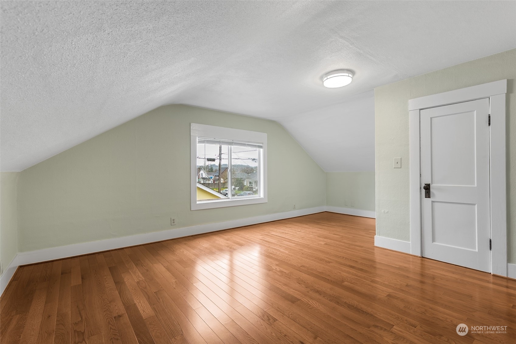 190 Southwest Lewis Street Chehalis, WA 98532 - Photo 22 of 30 an empty room with wooden floor and windows