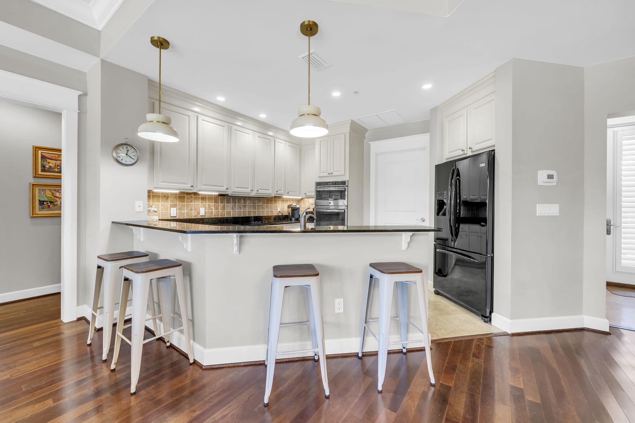 5360 Pine Ridge Lane, Unit 5360 Miramar Beach, FL 32550 - Photo 17 of 44 a kitchen with kitchen island granite countertop a sink a stove a refrigerator and island with wooden floor