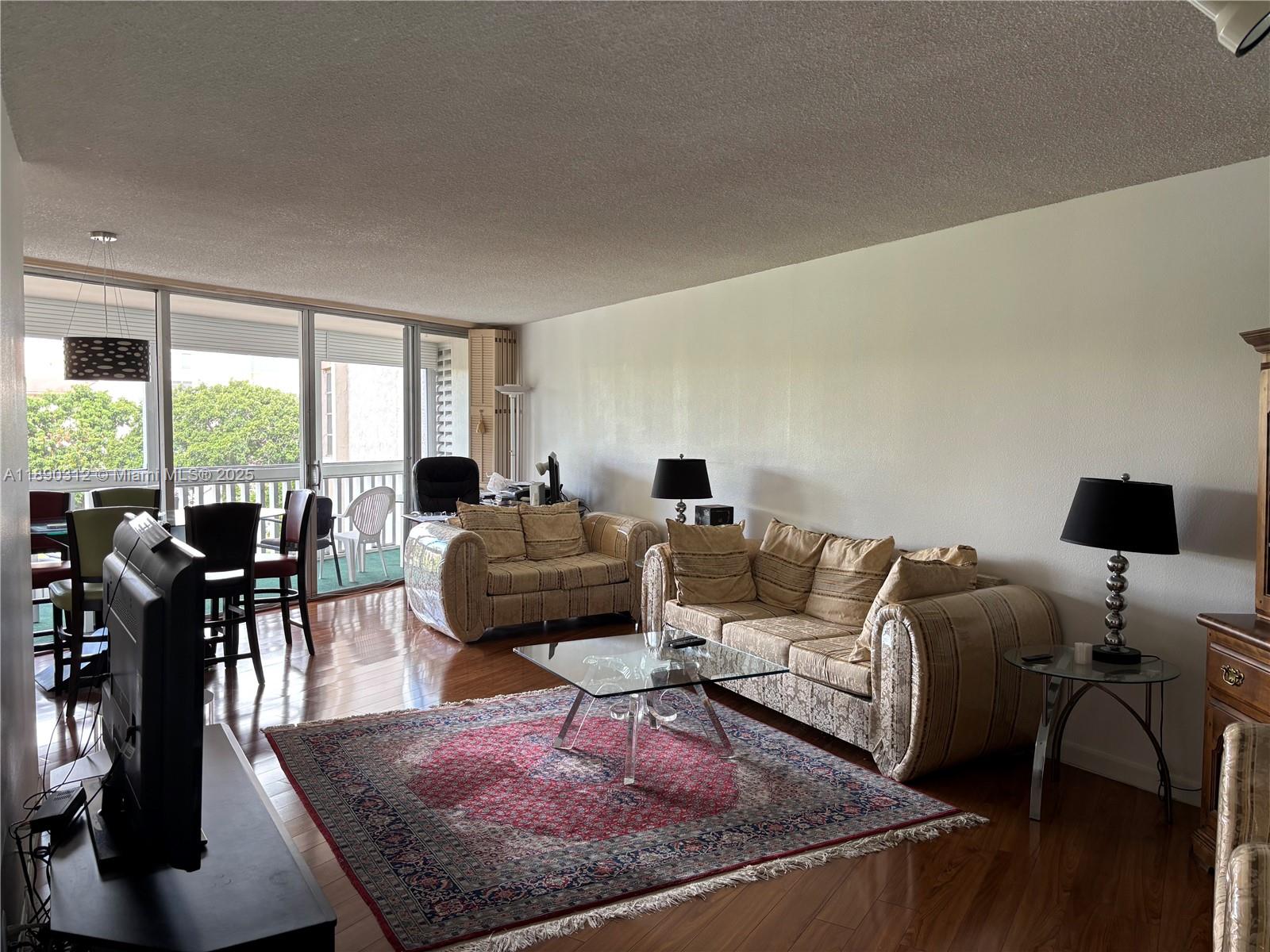 6901 Environ Boulevard, Unit 3F Lauderhill, FL 33319 - Photo 1 of 16 a living room with furniture and a large window
