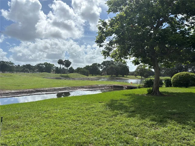 a view of outdoor space with swimming pool and green space