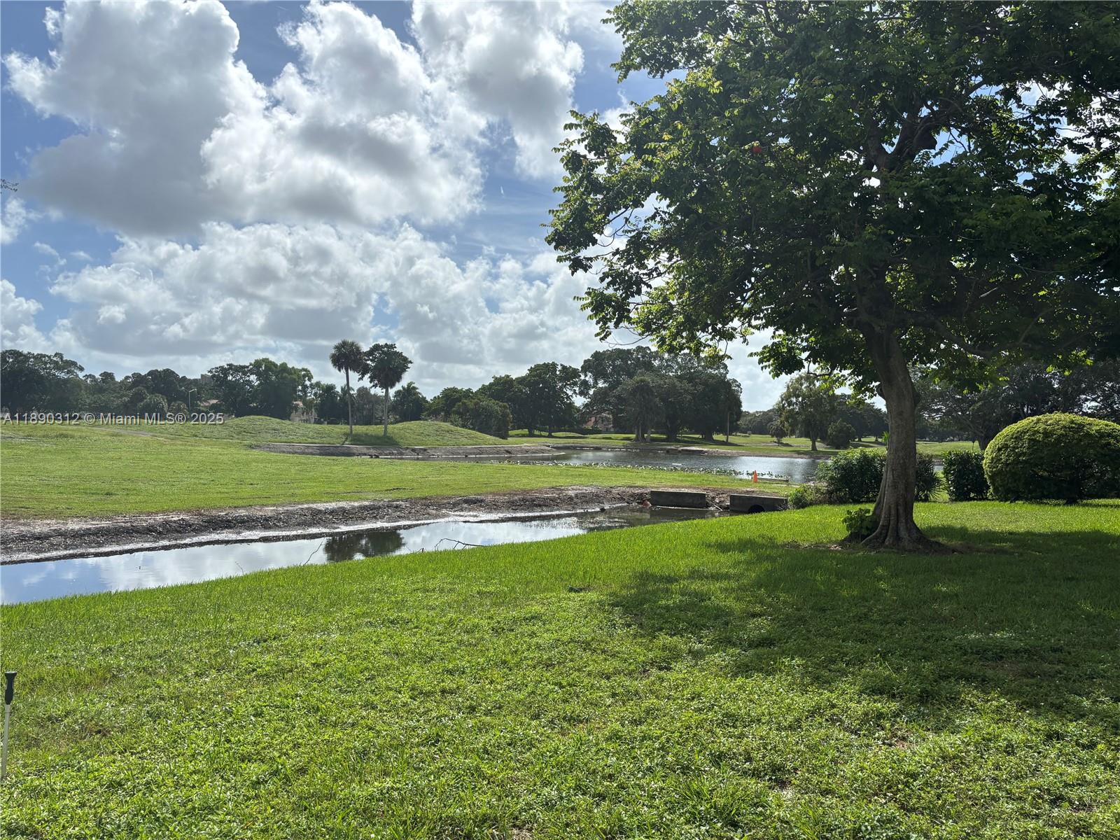 6901 Environ Boulevard, Unit 3F Lauderhill, FL 33319 - Photo 15 of 16 a view of outdoor space with swimming pool and green space