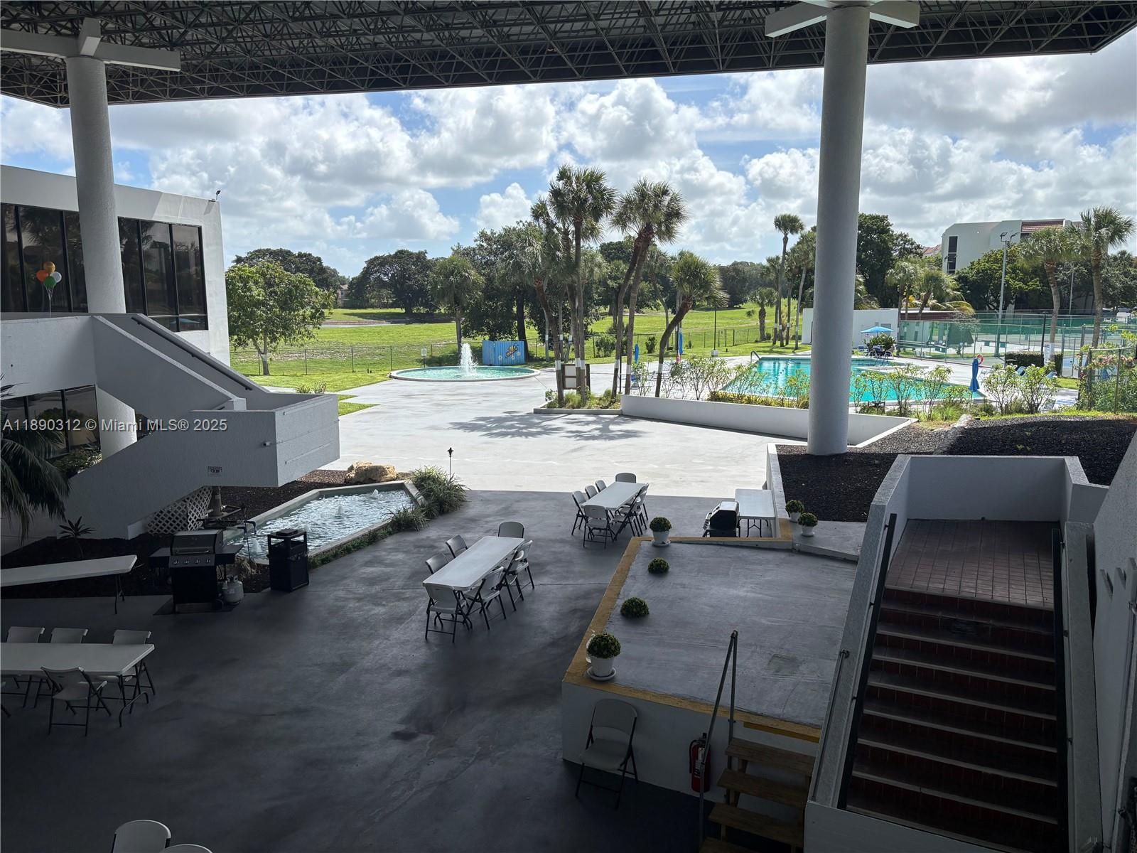 6901 Environ Boulevard, Unit 3F Lauderhill, FL 33319 - Photo 16 of 16 a view of a patio with lawn chairs next to a yard