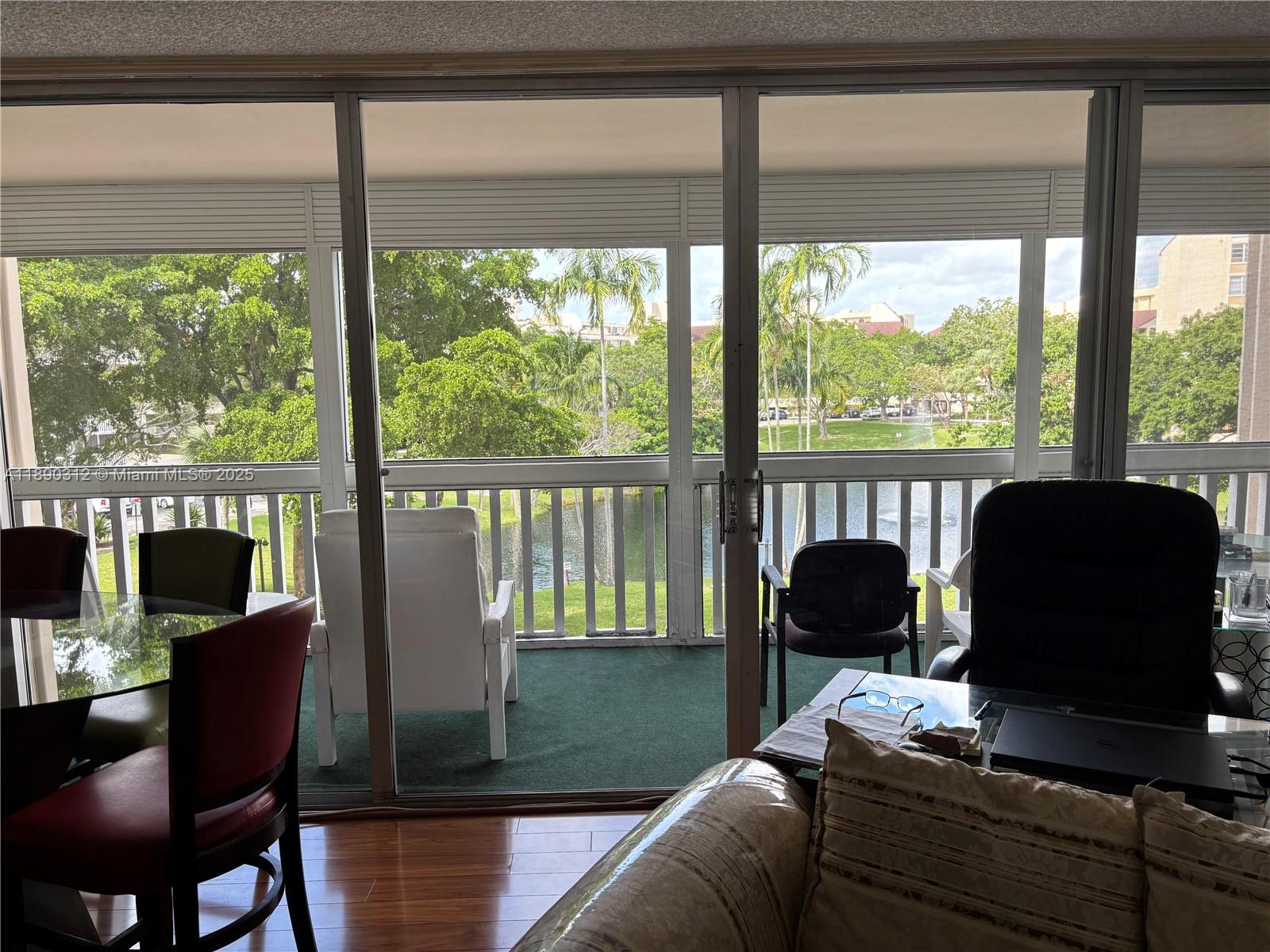 6901 Environ Boulevard, Unit 3F Lauderhill, FL 33319 - Photo 3 of 16 a living room with furniture and a floor to ceiling window