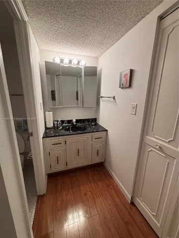 a kitchen with wooden floors and white appliances