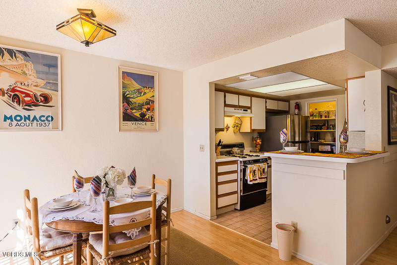 1225 Fitzgerald Road, Unit B Simi Valley, CA 93065 - Photo 11 of 34 a kitchen with stainless steel appliances kitchen island granite countertop a table and chairs in it