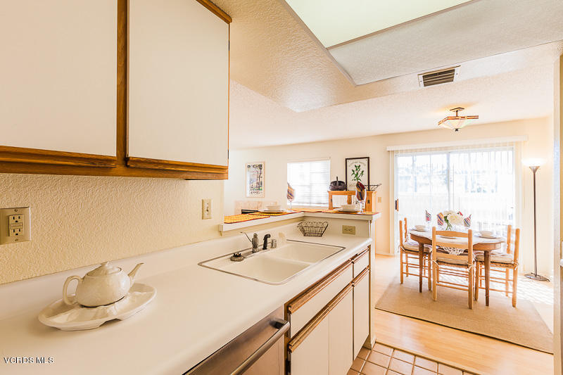 1225 Fitzgerald Road, Unit B Simi Valley, CA 93065 - Photo 16 of 34 a kitchen with a sink a table and chairs in it