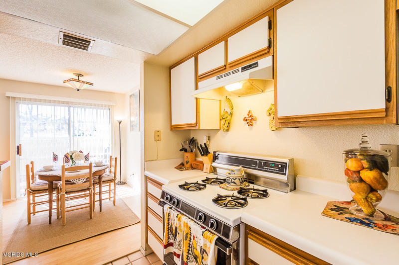 1225 Fitzgerald Road, Unit B Simi Valley, CA 93065 - Photo 17 of 34 a kitchen with a stove and a dining table