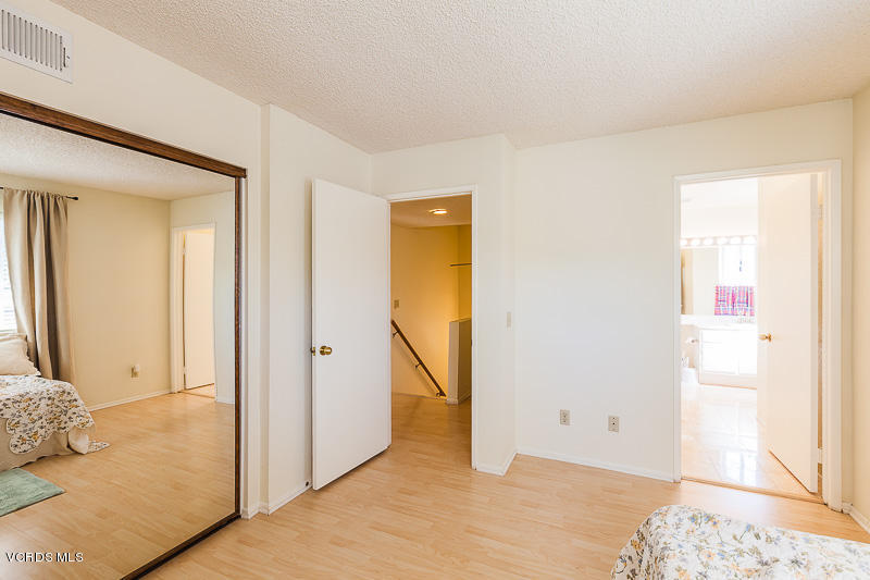 1225 Fitzgerald Road, Unit B Simi Valley, CA 93065 - Photo 20 of 34 a view of a bedroom with wooden floor and bathroom