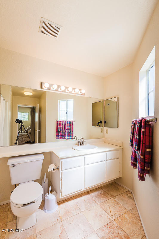 1225 Fitzgerald Road, Unit B Simi Valley, CA 93065 - Photo 22 of 34 a bathroom with a sink mirror vanity and toilet