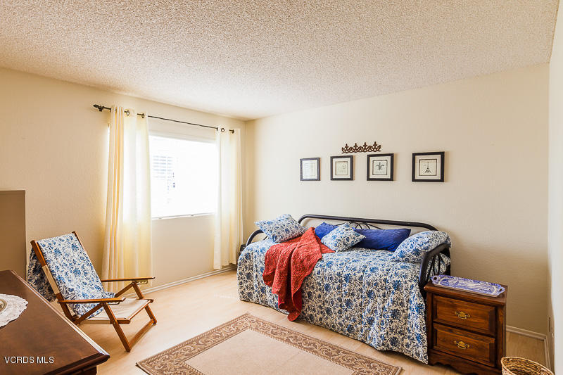 1225 Fitzgerald Road, Unit B Simi Valley, CA 93065 - Photo 23 of 34 a bedroom with a bed and chair