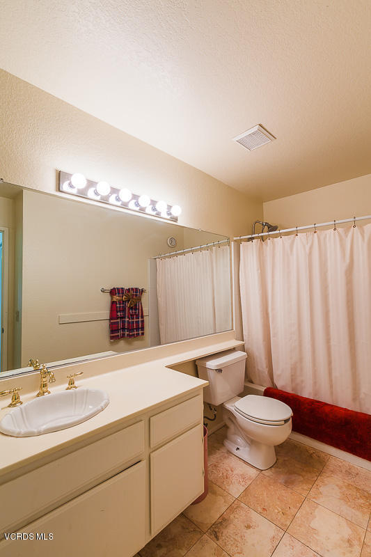 1225 Fitzgerald Road, Unit B Simi Valley, CA 93065 - Photo 27 of 34 a bathroom with a double vanity sink and a mirror