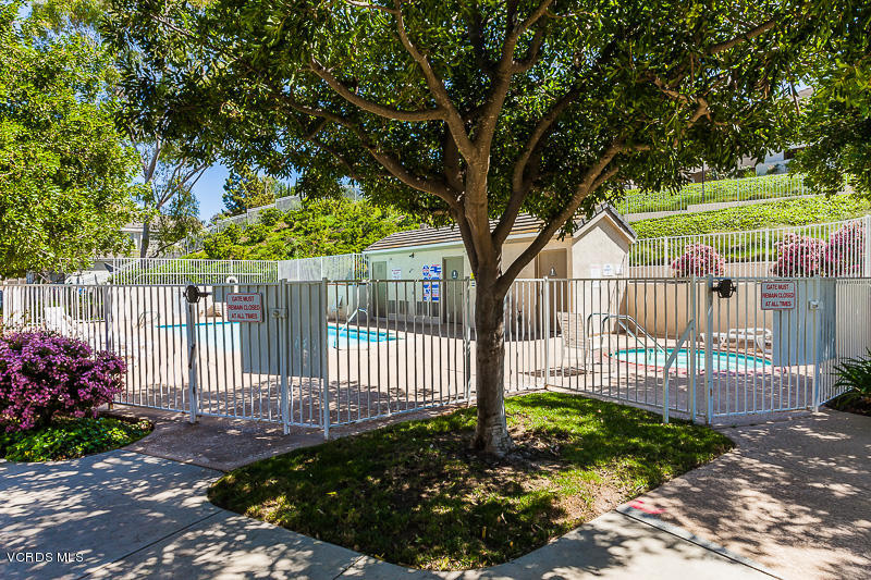 1225 Fitzgerald Road, Unit B Simi Valley, CA 93065 - Photo 32 of 34 a view of a house with a small yard and a garden