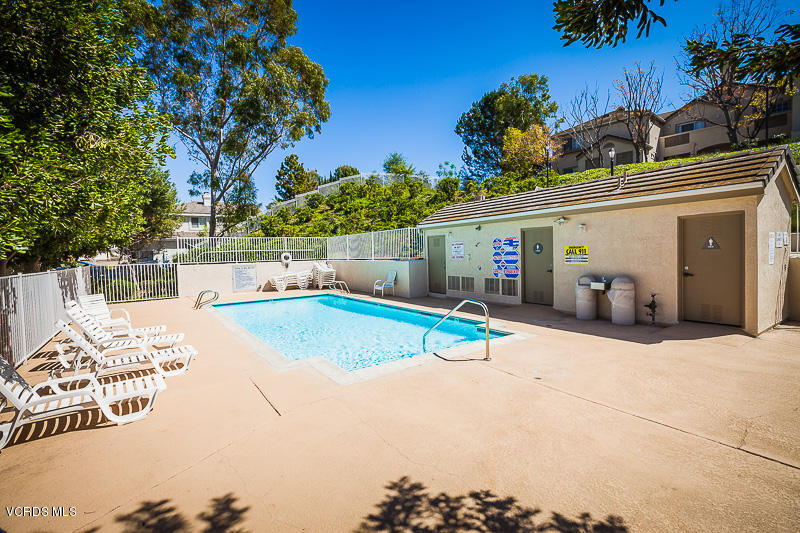 1225 Fitzgerald Road, Unit B Simi Valley, CA 93065 - Photo 33 of 34 a view of a white house with a yard and potted plants